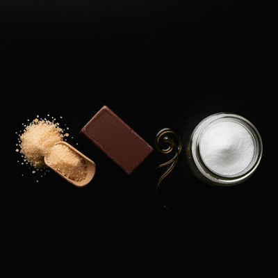 Assortment of vegan chocolate ingredients like cocoa beans, agave, and coconut sugar